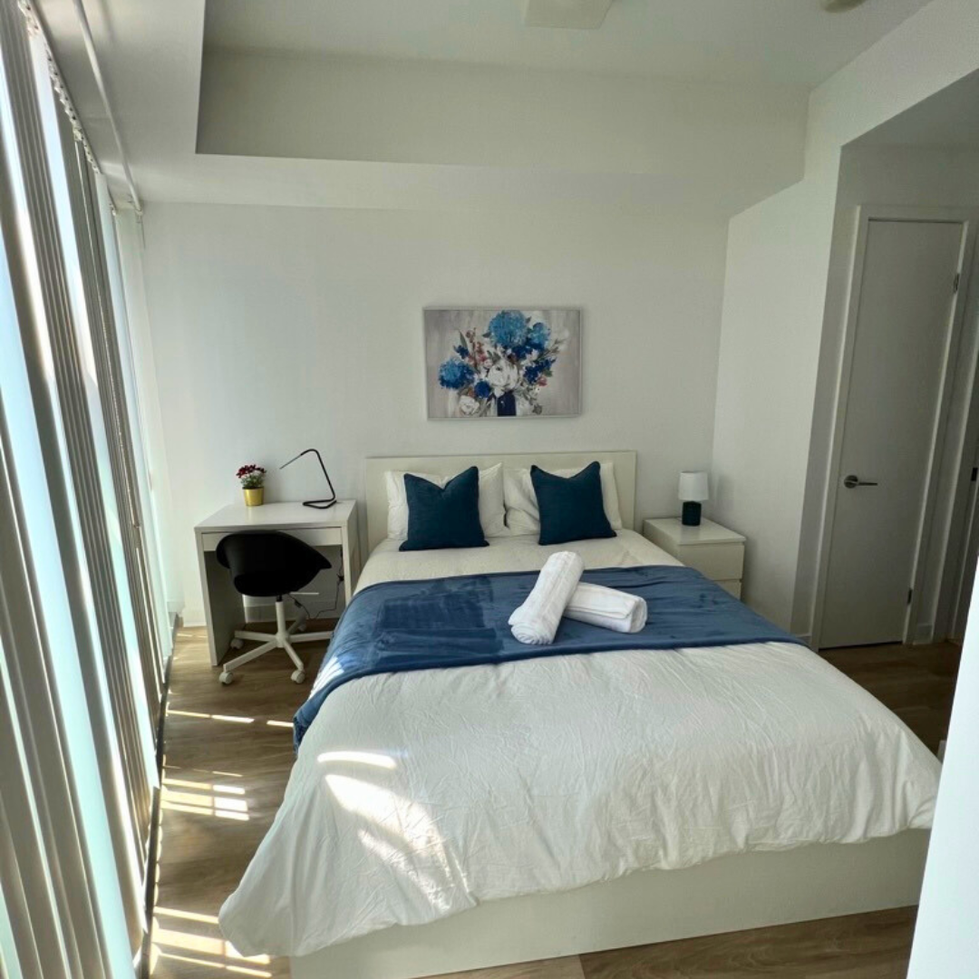 Bright and tidy living room with freshly vacuumed carpet and arranged furniture.