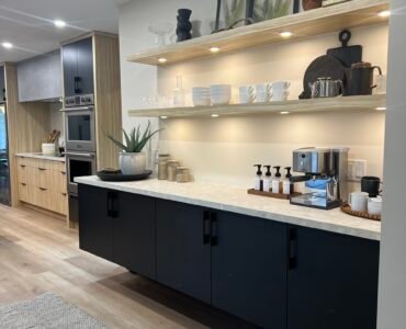 Freshly cleaned modern kitchen space with open shelves and under-cabinet lighting.