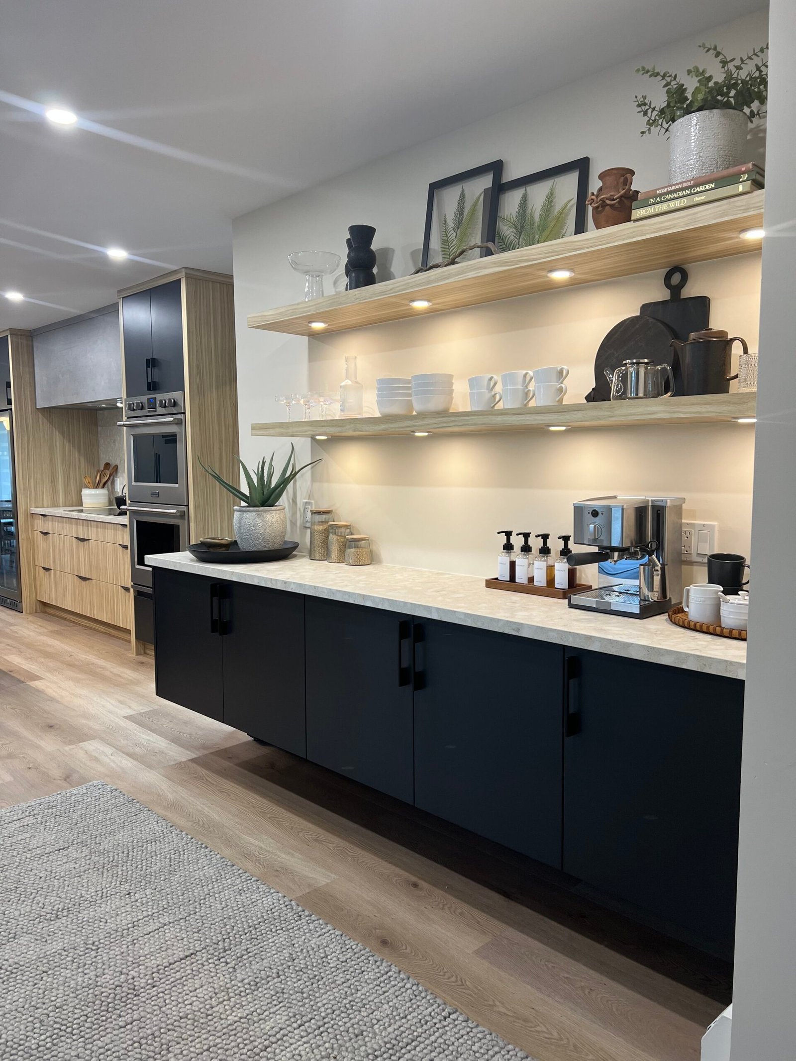 Freshly cleaned modern kitchen space with open shelves and under-cabinet lighting.