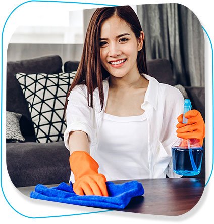 Smiling professional cleaner holding spray bottle and blue cloth, ready for cleaning tasks