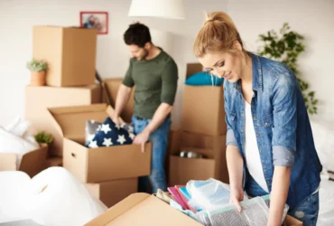Couple sorting belongings while packing for decluttering and moving